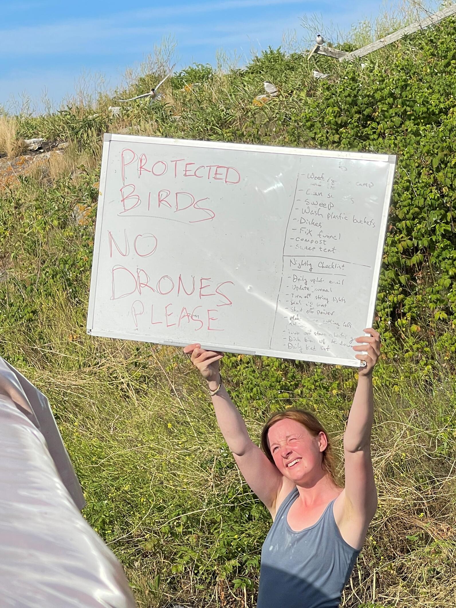 Researcher with No Drones Sign on Pond Island NWR